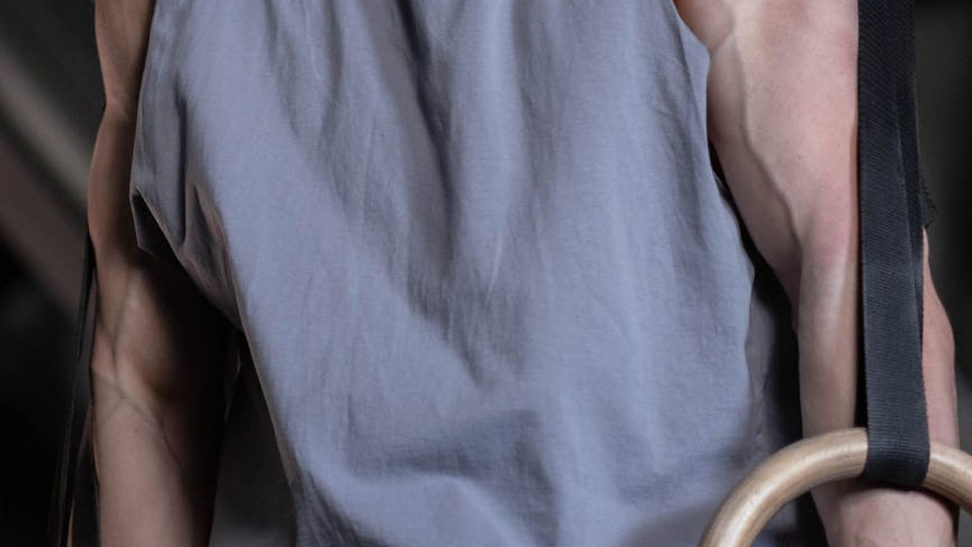 Man performing steady strength exercises in a modern gym.