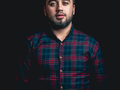 Strong silhouette of a man standing against a window.